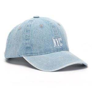 Detail of white NYC embroidery on a light blue denim vintage style baseball cap
