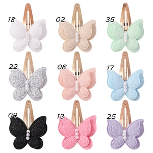 Detail view of double-layer lace butterfly hair clips with pearls in nine vibrant colors