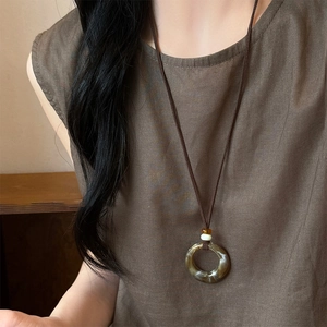Retro resin geometric round pendant necklace with amber texture and dark brown cord