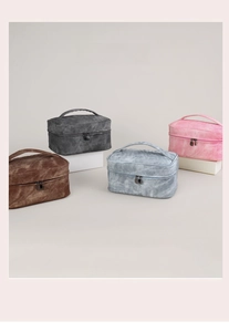 Detail view of large travel toiletry bags in four colors with marble texture and handle