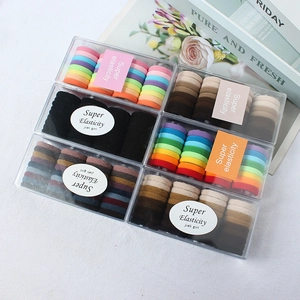 Set of colorful velvet elastic hair ties in six minimalist assorted color boxes