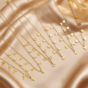 Detail of gold-plated stainless steel necklaces with heart, star, and cross charms