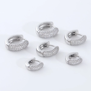 Macro detail of iced-out hoop earrings with three different sizes of micro-paved zircons