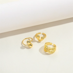 Three-piece set of adjustable gold open rings with heart, bead, and braided designs