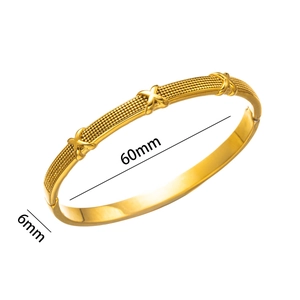 Minimalist gold titanium steel bangle with X-pattern and 60mm inner diameter