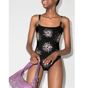 Detail of black one-piece swimsuit with sequined sunflower patterns and sparkling rhinestones