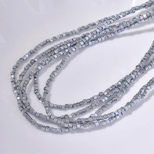 2mm rainbow hematite cube beads necklace with silver metallic luster on white background