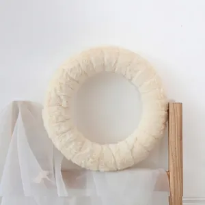 Minimalist beige wool felt round plush ornament displayed on a modern wooden shelf