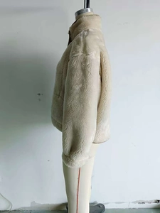 Detailed side profile of beige fleece jacket with stand-up collar on mannequin