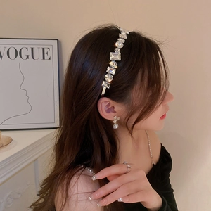 Macro shot of sparkling square and round crystal headband with elegant silver alloy base
