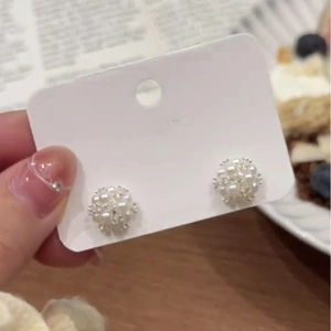 Elegant silver needle stud earrings featuring a sophisticated white pearl flower cluster design