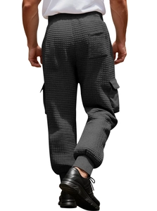 Detail view of dark grey men's waffle textured cargo joggers with large side pockets