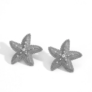 Silver starfish stud earrings with white zircons and realistic textured metal surface