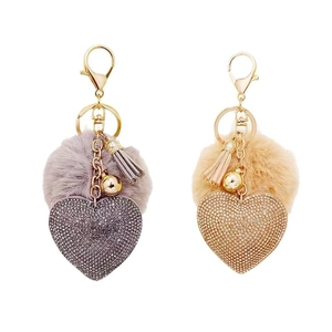 Sparkling rhinestone heart keychains with soft faux fur pom-poms in beige and lilac