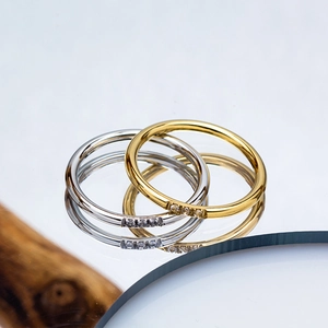 Minimalist 2.5mm stainless steel rings in gold and silver with three inset diamonds