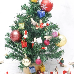 Mini Christmas tree decorated with colorful balls, gift boxes and themed wooden clips