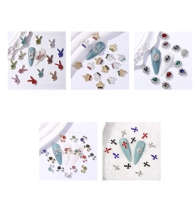 Detailed view of alloy star and crown nail charms with colorful crystals for 3D art