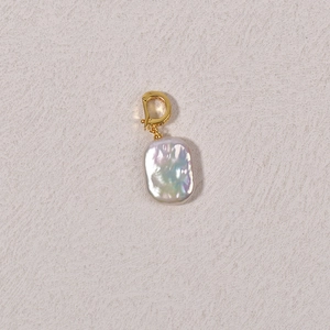 Golden Baroque pearl pendant with rainbow luster on a minimalist beige background