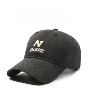 Close-up of N GRACE embroidery detail on dark grey twill cotton baseball cap