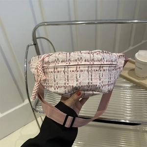 Pink tweed checkered crossbody chest bag with adjustable strap and textured fabric