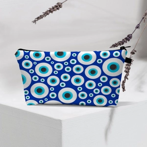Detail of waterproof Evil Eye makeup bag with blue pattern on white canvas and black zipper