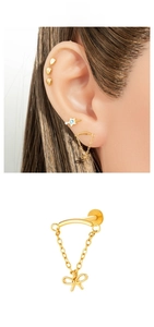 Detail of gold titanium butterfly stud with dangling chain fringe and screw-back labret