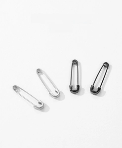 Detail of S925 sterling silver safety pin earrings in silver and black nickel finish