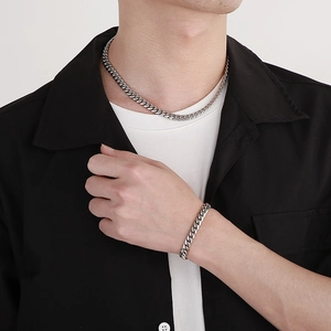 Silver cuban link necklace and bracelet set worn by a male model for hip-hop style