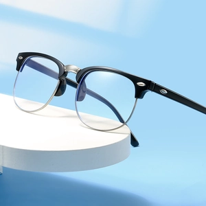 Classic black and silver half-frame eyeglasses on a pedestal with a blue background