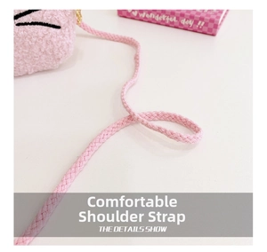 Close-up of comfortable pink braided shoulder strap on a soft plush crossbody bag