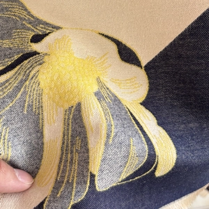 Close-up of magnolia floral pattern on navy cashmere-feel fabric with visible weave