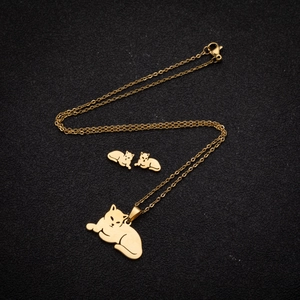 Polished golden stainless steel jewelry set featuring minimalist cat pendant and earrings