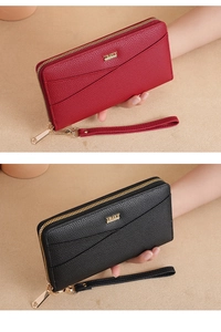 Detail showing red and black pebble leather wallets with wristlets and gold metal zippers