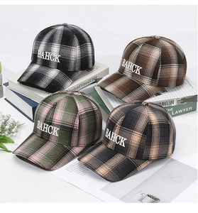 Detailed view of four plaid baseball caps with BAHCK embroidery in various colors