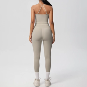 Detail of cross-back yoga top and high-waisted leggings in beige sport set