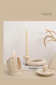 Detailed close-up of matte beige ceramic candle holders in minimalist Nordic design
