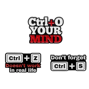 Three creative enamel pins featuring computer keyboard shortcuts Ctrl O, Z and S designs