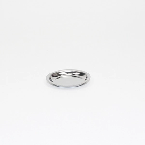 Polished stainless steel round saucer tray with smooth reflective surface for tea strainer
