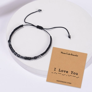 Handmade Morse Code Bracelet with black beads and 'I Love You' card on stone stand
