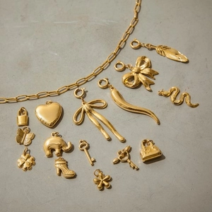Golden stainless steel jewelry charms set featuring heart, elephant and feather pendants