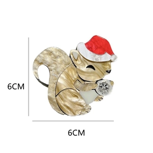 Detail shot of squirrel acrylic brooch with Christmas hat measuring 6cm by 6cm