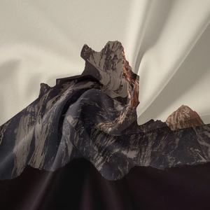 Detailed view of bohemian mountain print fabric showing silky texture and elegant folds