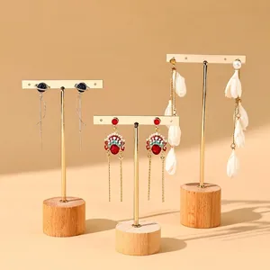 Golden T-bar earring display stands with wood bases for jewelry showcasing