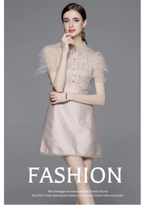 Detail of pink lace dress featuring layered mesh ruffle sleeves and elegant high collar