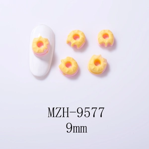 Detail of 9mm pink and yellow donut nail art charms with model MZH-9577 on white background