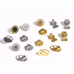 Close-up of assorted gold and silver earring backs showing butterfly and disk styles