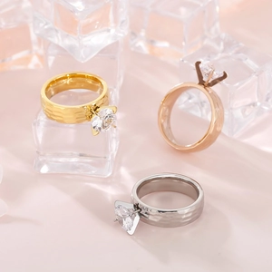 Detailed view of three 6mm hammered texture rings with four-prong zircons on ice cubes