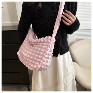 Detail shot of pink bubble textured tote bag with pleated fabric and thick shoulder strap