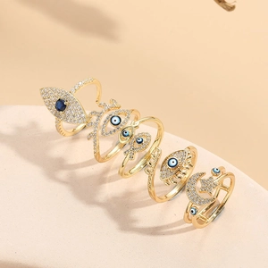 Gold evil eye and moon star rings set with blue gemstones and sparkling zircons