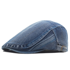 Detail view of washed denim beret featuring textured fabric and adjustable metal side buckle